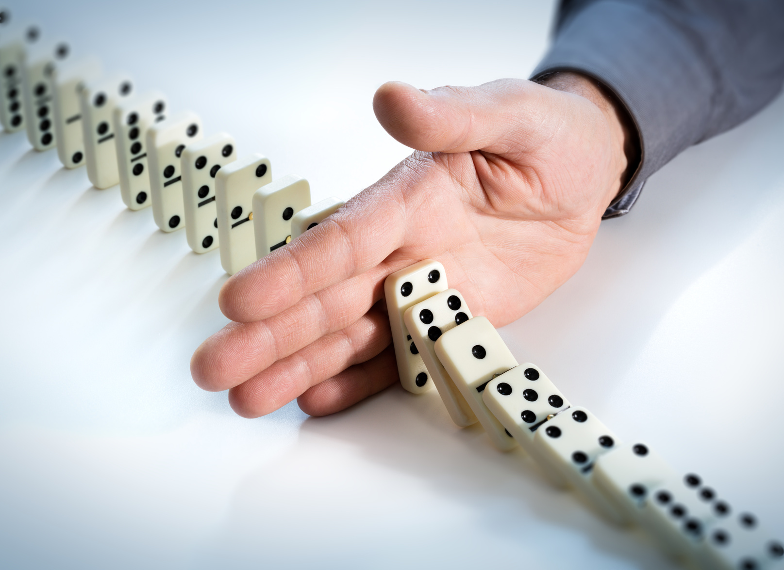 Stop Domino Effect - Hand Prevents Failure. 
