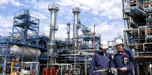 Two men in front a power station